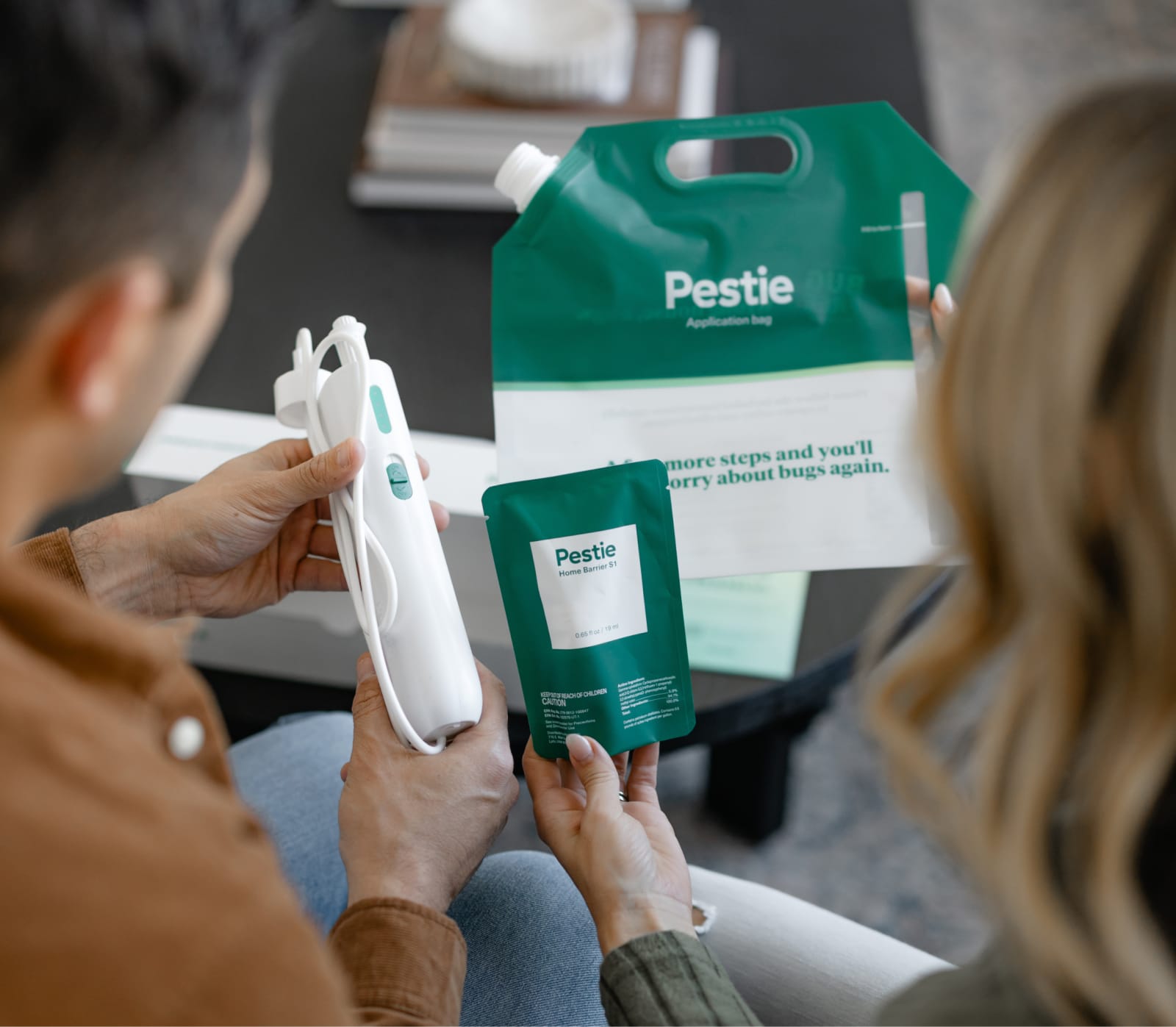 Woman spraying Pestie near ferns.